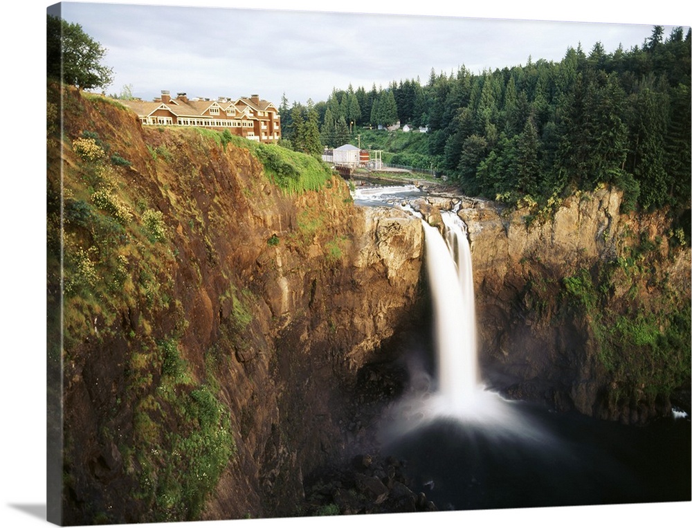 USA, Washington State, Salish Lodge and English Daisies overlook the 270 tall Snoqualmie Falls.