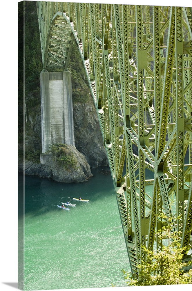 USA, Washington, Whidbey Island, Deception Pass. Kayakers emerge from shadow of cliffs. Known for dangerous currents, pass...