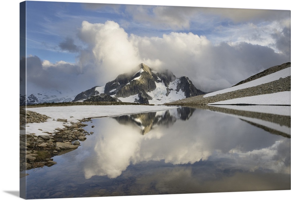 Whatcom Peak shrouded in clouds and reflected in upper Tapto Lake, North Cascades National Park, Washington State