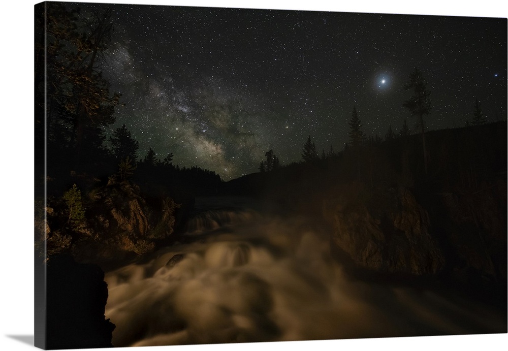 USA, Wyoming, Yellowstone National Park. Milky Way floats above a waterfall on the Firehole River in Yellowstone National ...