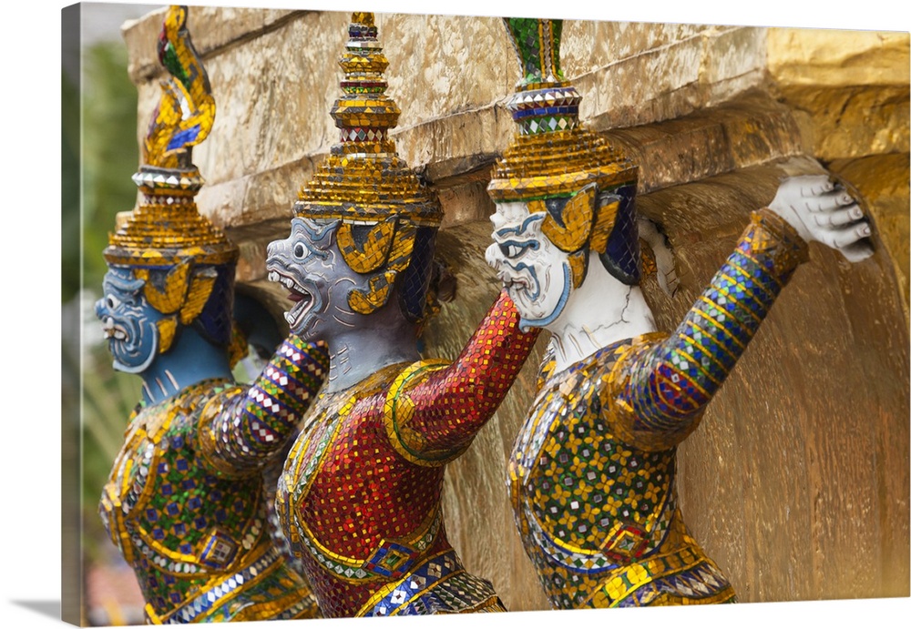 Thailand, Bangkok, Royal Palace. Yaksha guard one of the golden chedi at Wat Phra Kaew.