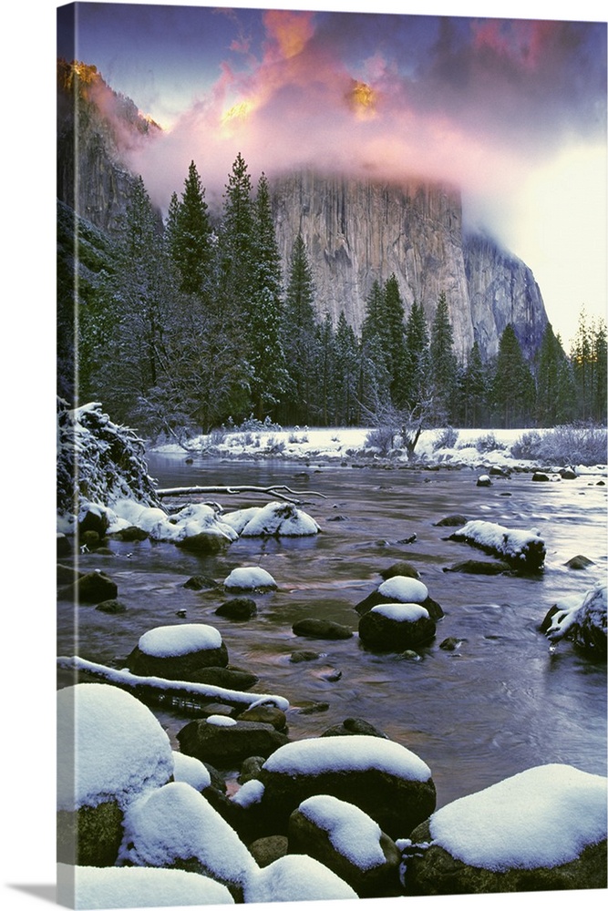 USA, California, Yosemite National Park. Sunlight on clouds over El Capitan as seen from the Merced River in winter.