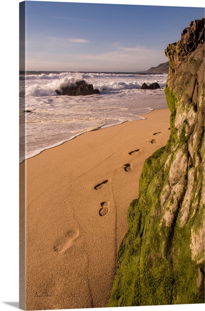 Footprints and sand beach along the California Coast, Garapata Beach, California, USA.