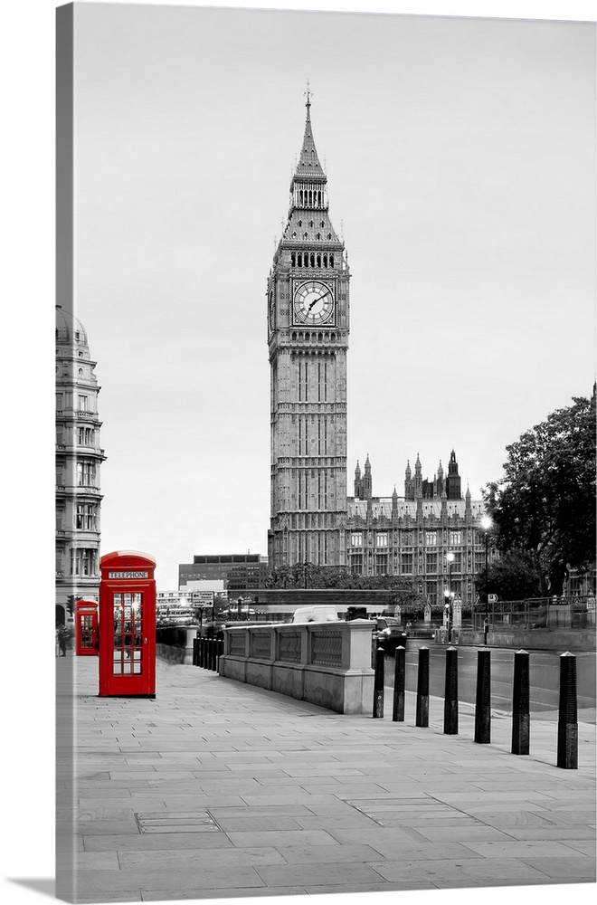 A traditional red phone booth in London with Big Ben in the background.