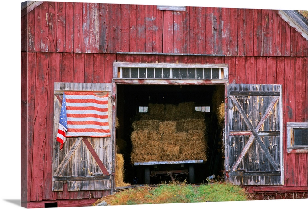 American flag hanging from a barn door.