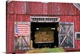 image thumbnail of American flag hanging from a barn door.