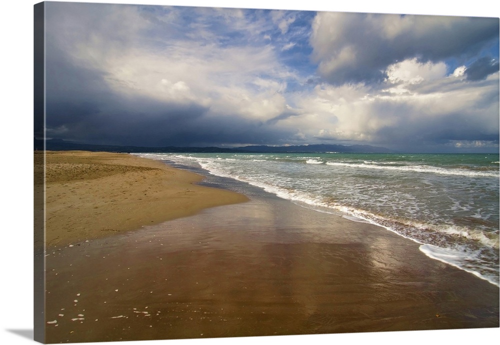 Storm clouds approaching a deserted beach.