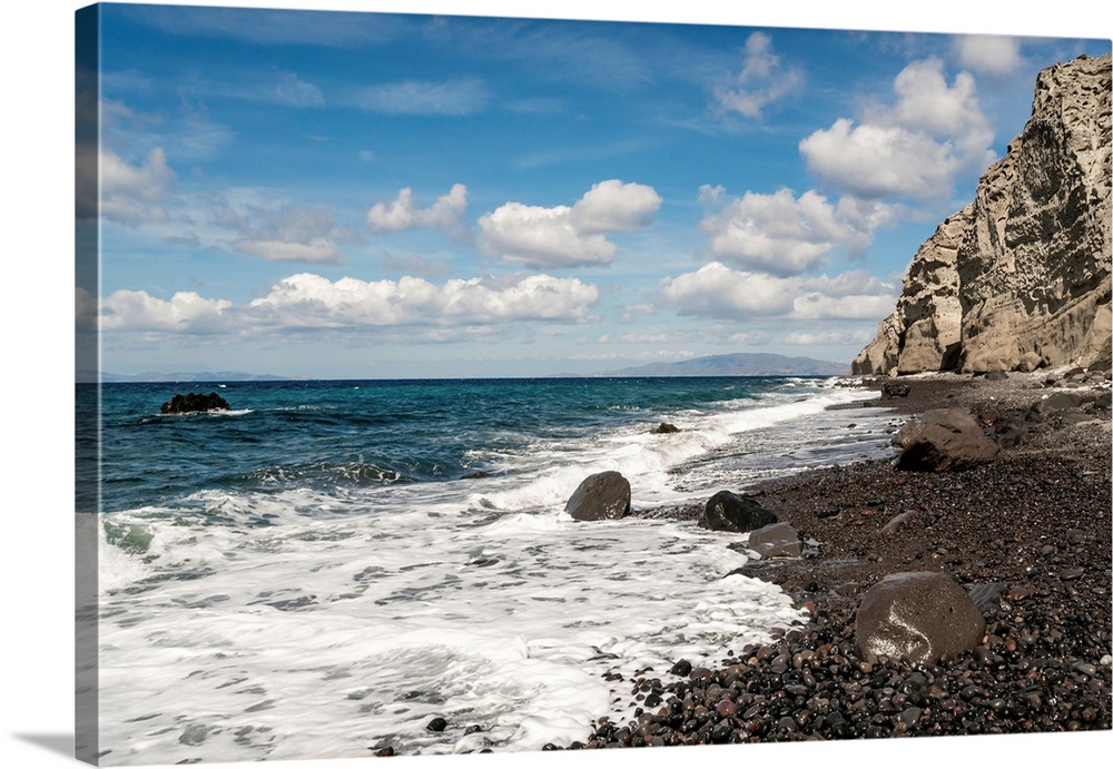 Blue aegean sea near rocks against sky with clouds.