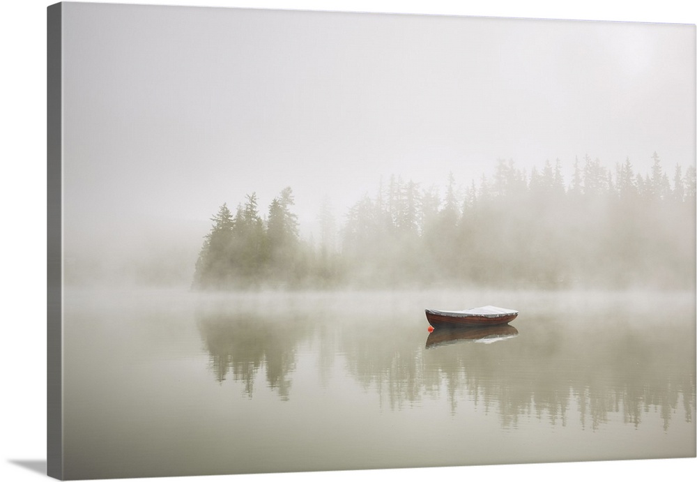 Boat on the lake at morning fog.