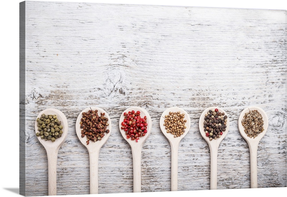 Collection of spices on a wooden spoon.