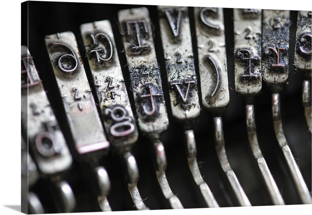 Detail of the gavel with inked letters of an old mechanical typewriter.