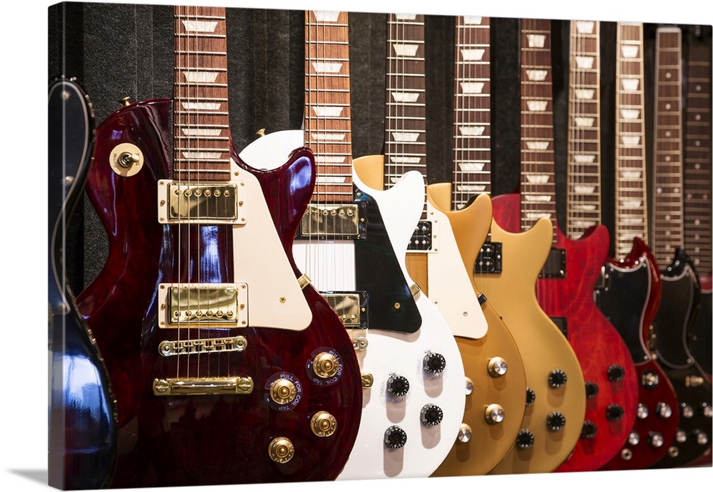 A row of electric guitar on display.
