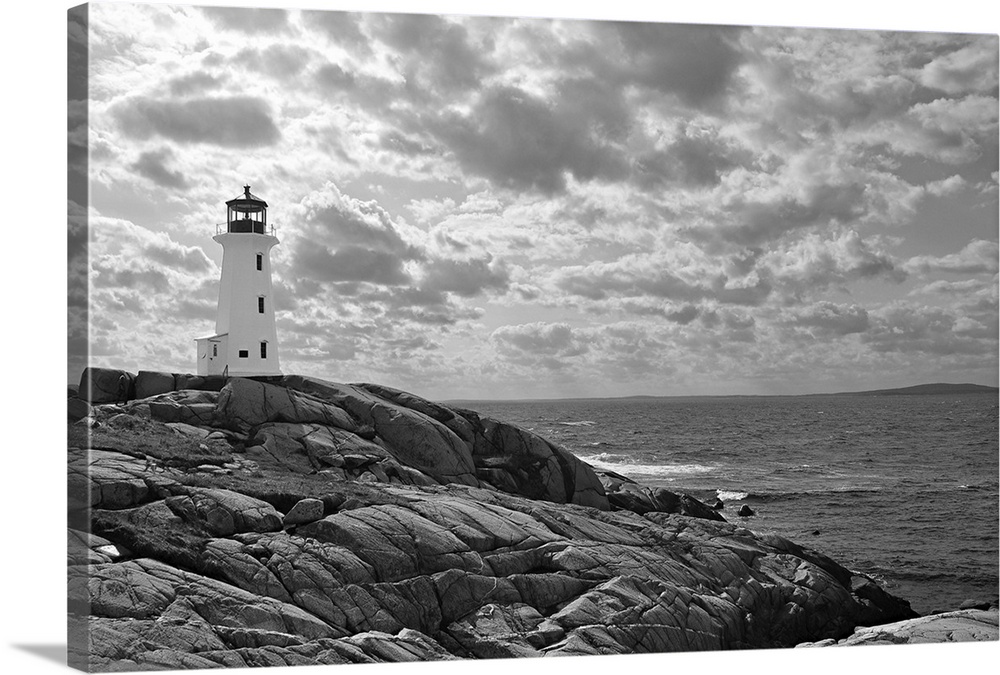 Lighthouse at Peggy's Cove, Nova Scotia in black and white with dramatic clouds in sky.