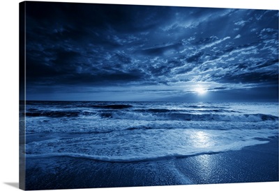 Midnight Blue Coastal Moonrise With Dramatic Sky And Rolling Waves