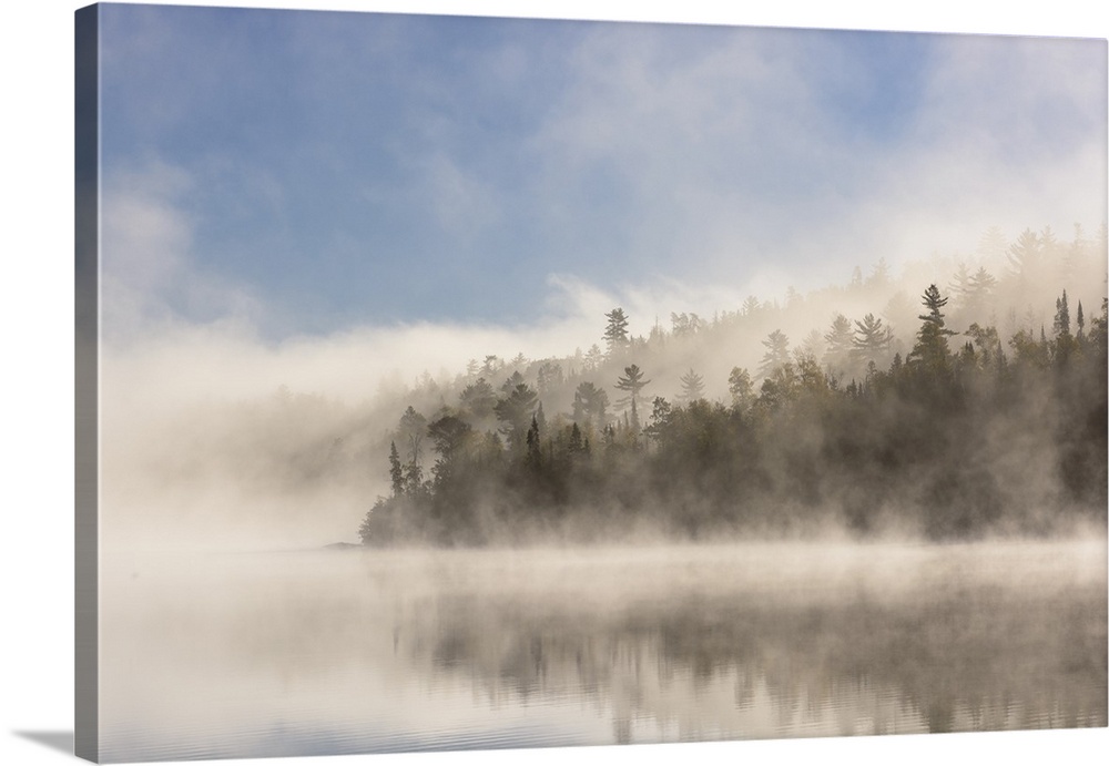 Fog clearing on Ottertrack lake in the boundary waters.