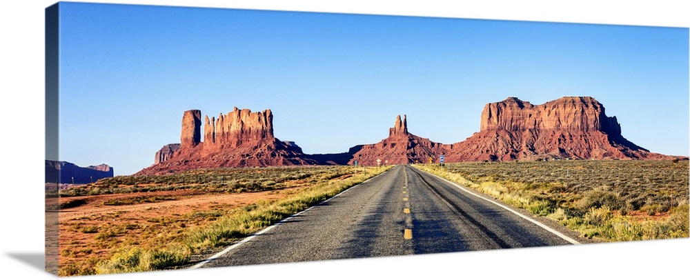 Panoramic view of long road at monument valley, USA.