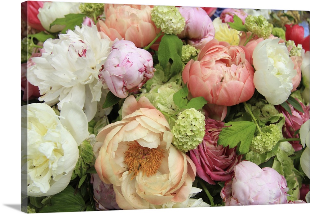 Peonies in various shades of pink and white in a floral wedding arrangement.