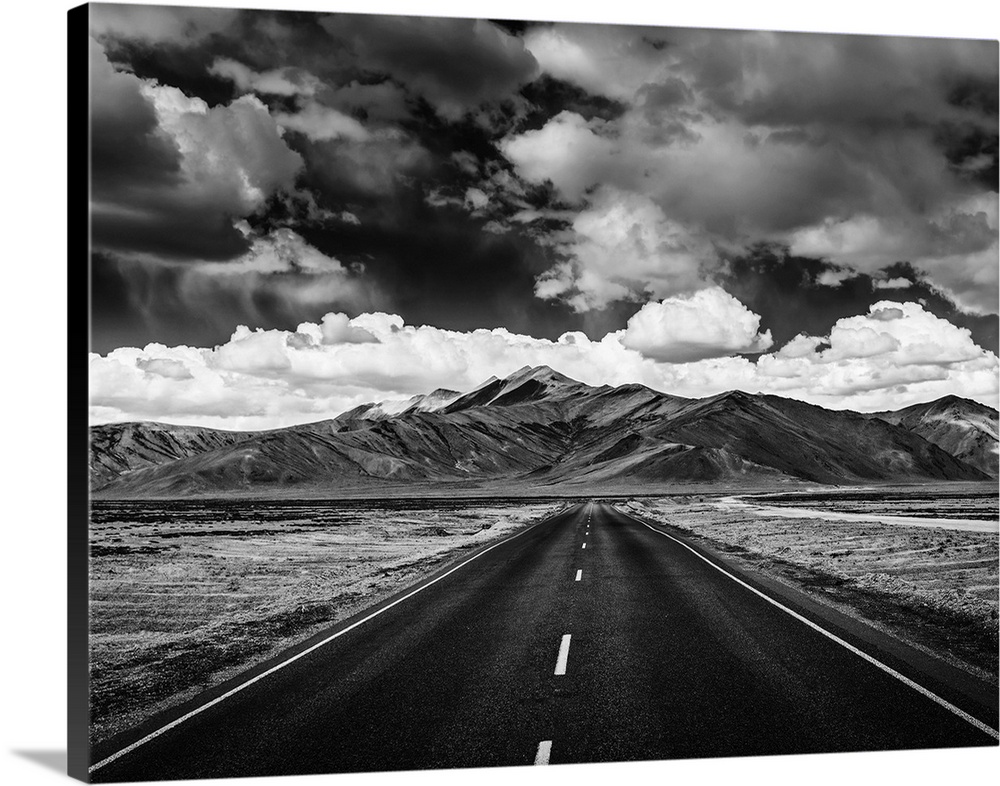 Travel forward concept background - road on plains in Himalayas with mountains and dramatic clouds. Manali-leh road, Ladak...