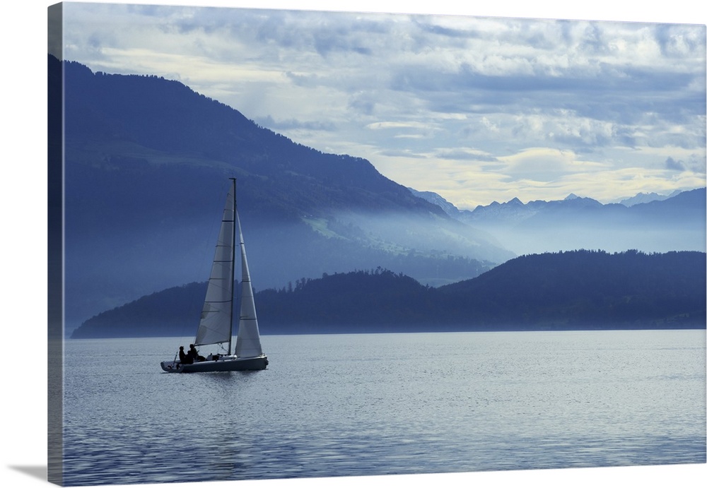 Sailing on Lake Zug in Switzerland with the Alps in the background.