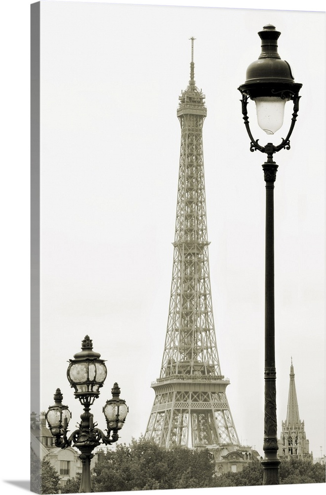Street lanterns on the Alexandre III Bridge against the Eiffel Tower in Paris, France.