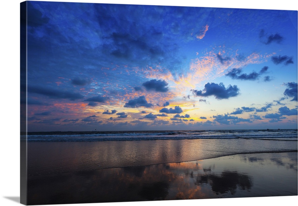 Tropical vacation/holiday concept of sunset on idyllic beach. Baga, Goa, India.