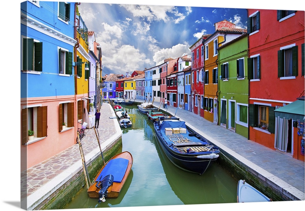 Venice, Burano Island Canal. Small colored houses and the boats.