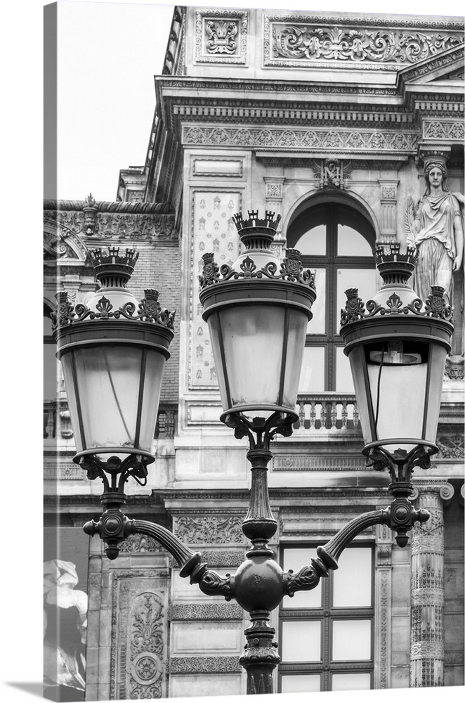 Vintage street lantern detailed close-up in front of Louvre museum, Paris, France. Black and white image.