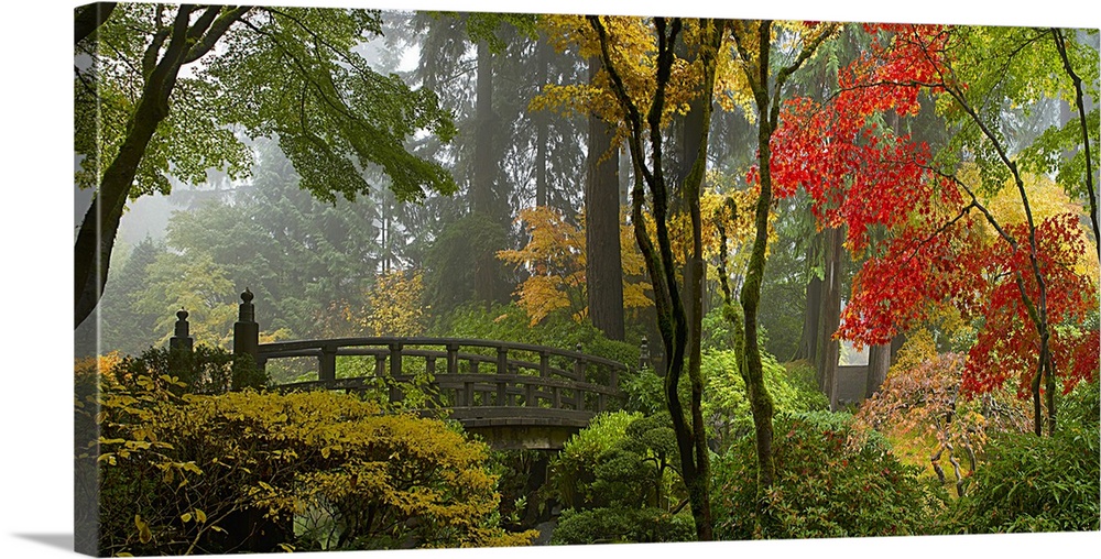 Wooden bridge at Portland Japanese Garden in fall one foggy morning.