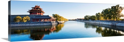 China, Beijing, Forbidden City, Corner tower and the walls surrounded by water at sunset