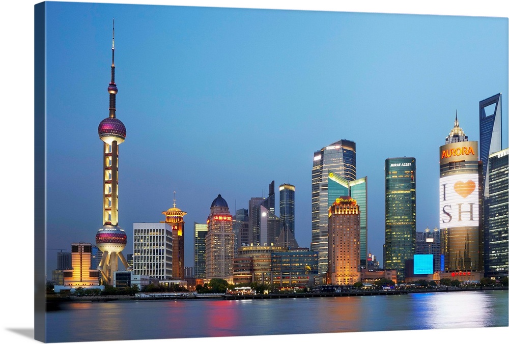 China, Shanghai, Pudong, Oriental Pearl Tower, Skyline with Oriental Pearl Tower and Huangpu River illuminated at night.