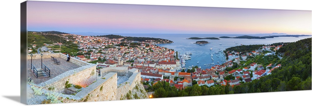 Croatia, Dalmatia, Hvar island, Lesina, Balkans, Adriatic Coast, Harbor illuminated at dusk.
