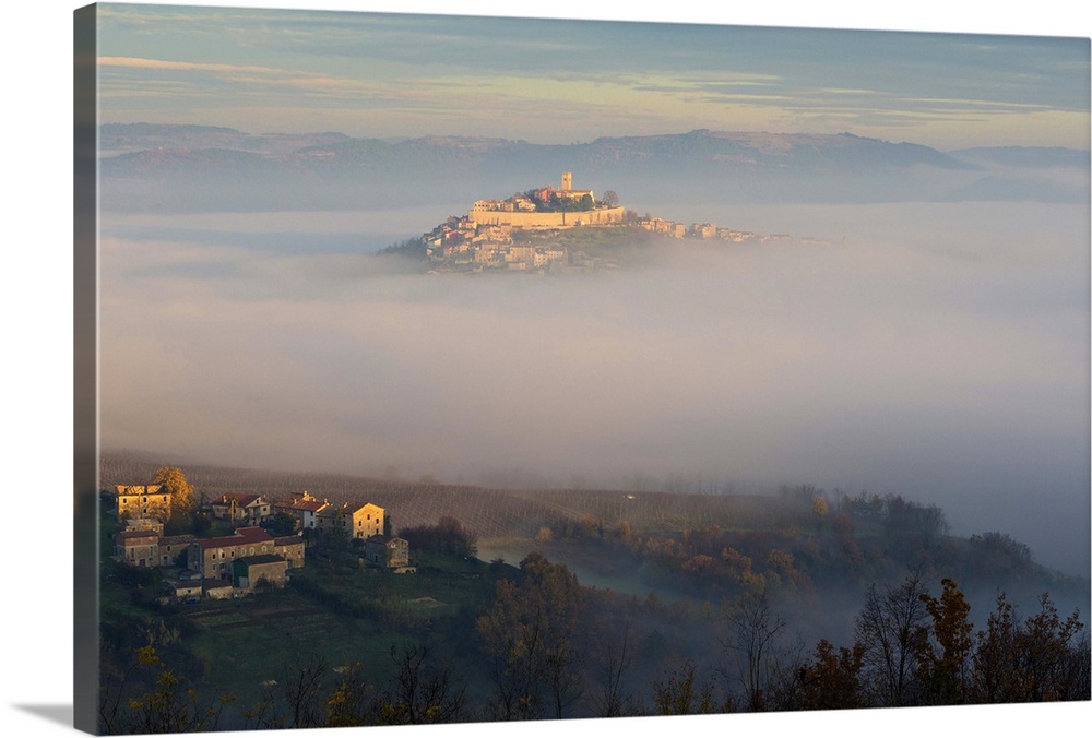 Croatia, Istria, Motovun, Village emerging from the mist at dawn.