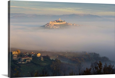 Croatia, Istria, Motovun, Village emerging from the mist at dawn