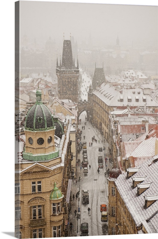 Czech Republic, Central Bohemia Region, Prague, Bohemia, Central Europe, View of the town under the snow from St Nicholaus...