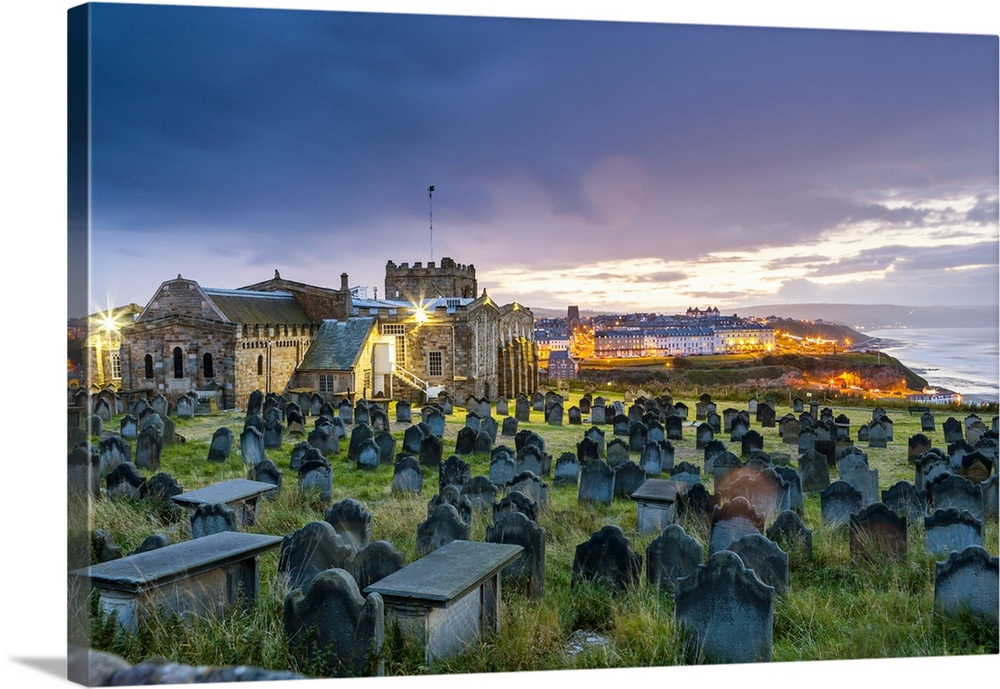 England, Great Britain, North Yorkshire, Whitby, Saint Mary's Parish Church with headstones at dusk