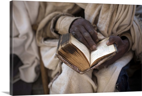 Ethiopia, Amhara, Lalibela, Priest reading an old Bible, Bete Maryam