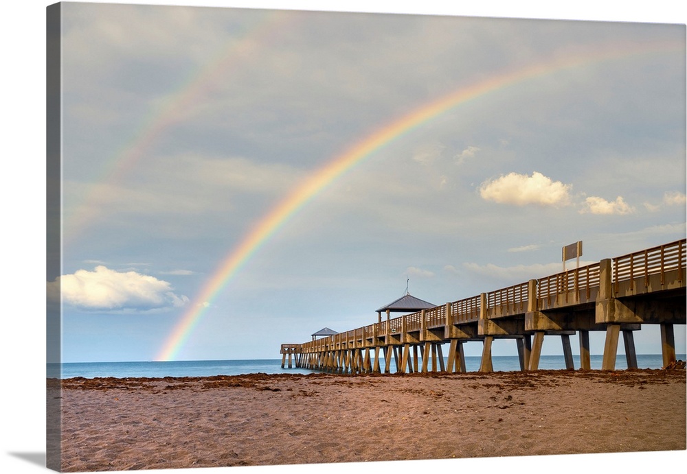 Florida, South Florida, rainbow over Juno Beach pier.