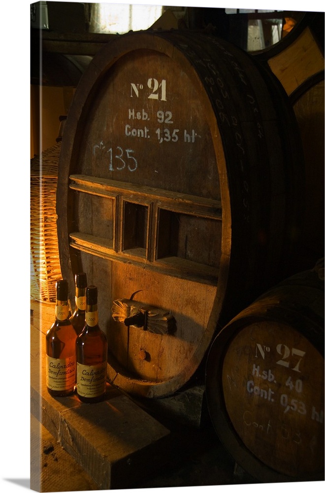 France, Normandy, Normandie, Barrels and bottlesn of Calvados in a producer's cellar