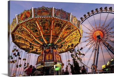 Germany, Bavaria, Munich, A carousel and big wheel, part of the Oktoberfest funfair