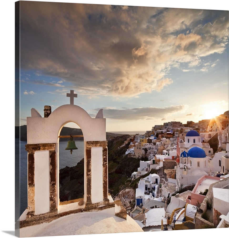 Greece, Aegean islands, Cyclades, Santorini island, Greek Islands, Oia, typical church bell overlooking the village at sun...