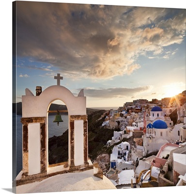 Greece, Santorini island, Oia, typical church bell overlooking the village at sunset