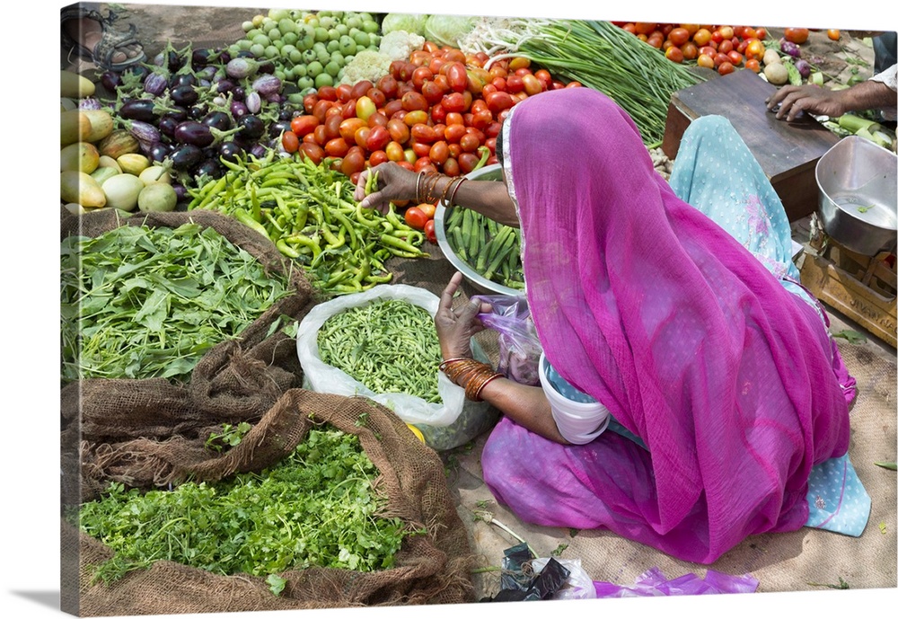 India, Rajasthan, Jaisalmer, A woman sells vegetables at a market
