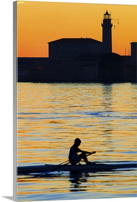 Italy, Friuli-Venezia Giulia, Trieste, Sunset on the sea with Lanterna and canoe