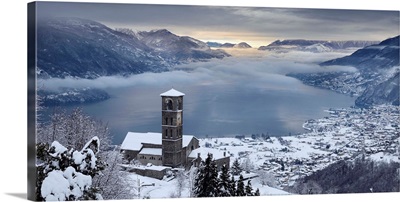 Italy, Lombardy, Como Lake, Peglio, Sant'Eusebio church and the lake with snow