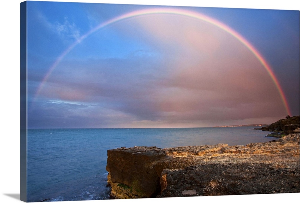 Italy, Sicily, Mediterranean sea, Costa Saracena, Siracusa district, Augusta, Rainbow over the sea at sunset.