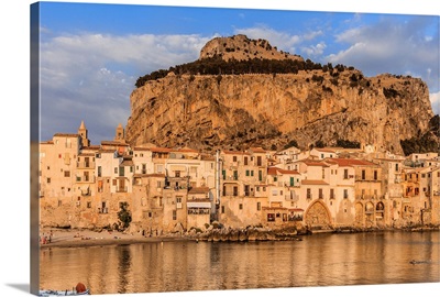 Italy, Sicily, Palermo district, Cefalu, Harbor and old town at sunset