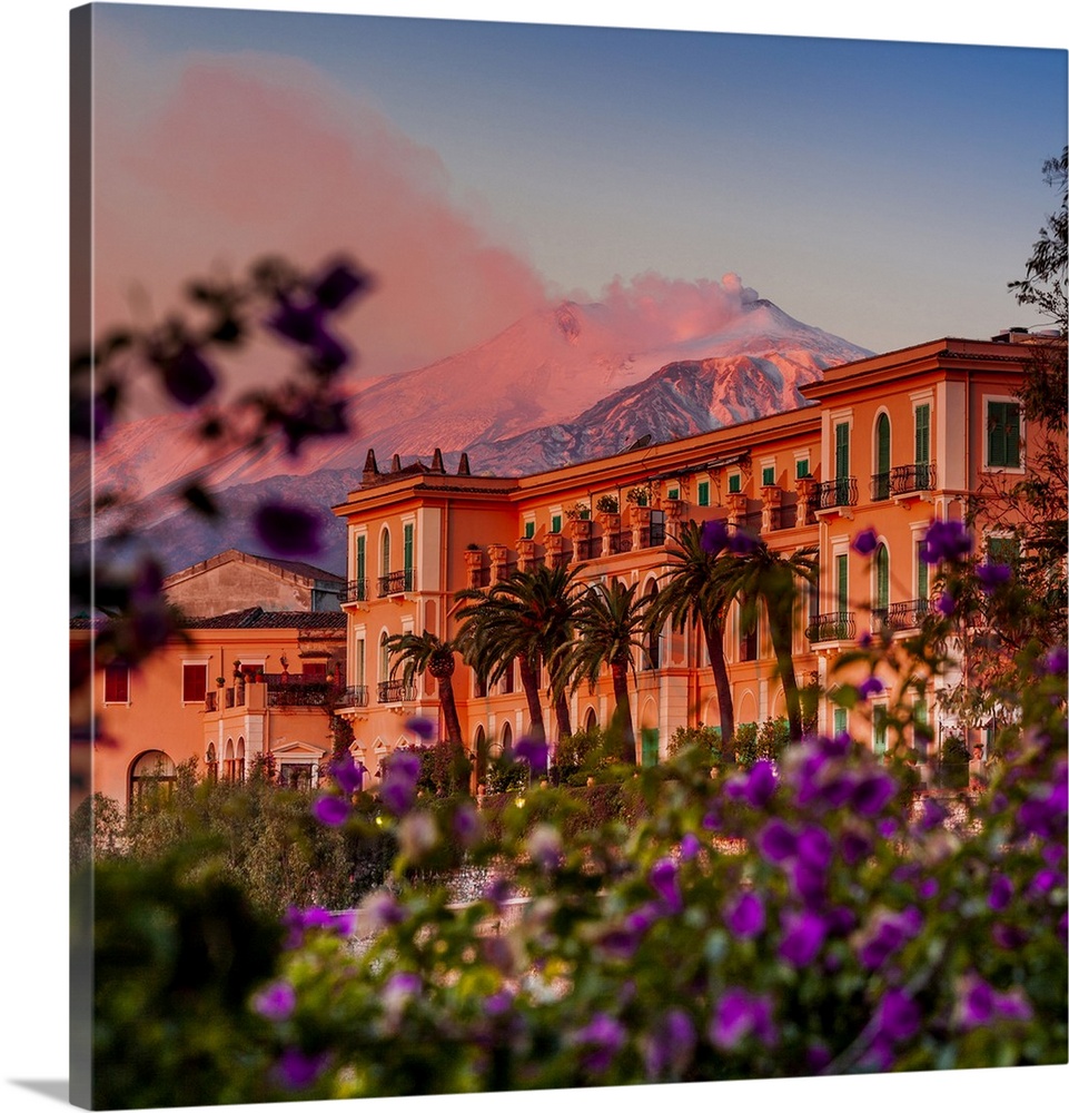 Italy, Sicily, Messina district, Taormina, San Domenico Palace Hotel at sunset with Mount Etna in the background.