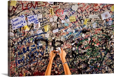 Italy, Veneto, Verona, A girl leaves a love message at the entrance to Juliet's House