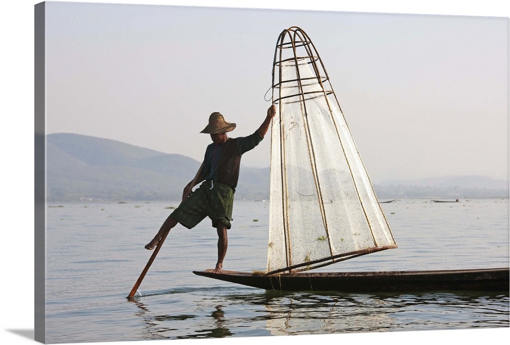 Myanmar, Shan, Fisherman on Inle Lake using traditional net rowing with one leg