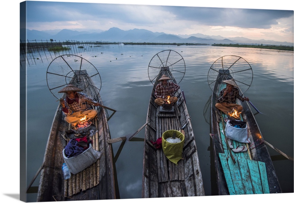 Myanmar, Shan, Nyaungshwe, Inle Lake, Local fisherman before dawn with fireplace on the boat